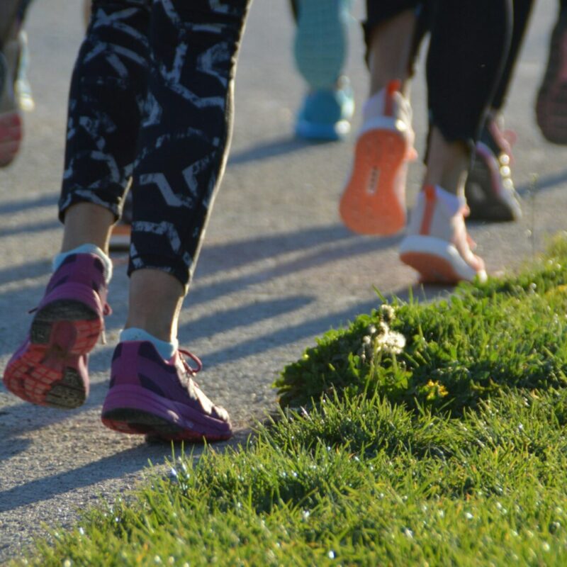 Group of people running - feet on the road