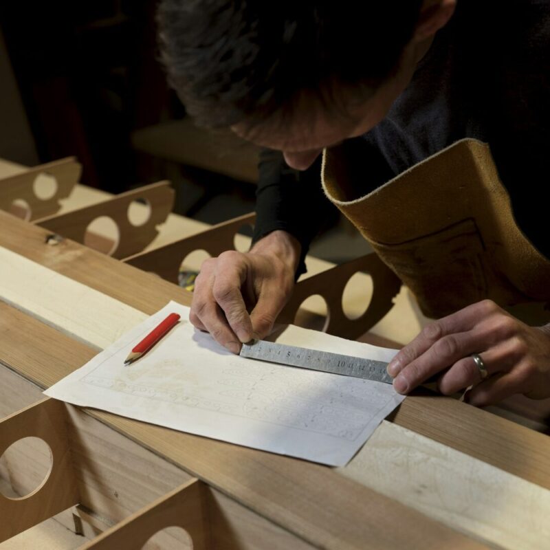 Man using metal ruler in design workshop